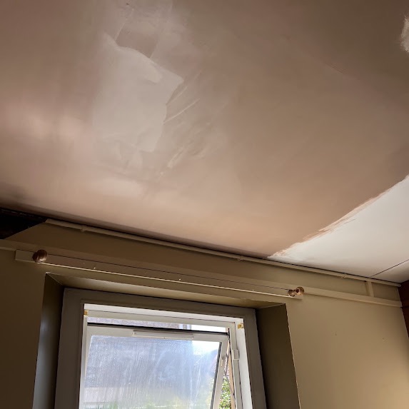 The same ceiling re-boarded with new plasterboard and insulation and skim-plastered smooth, ready to decorate