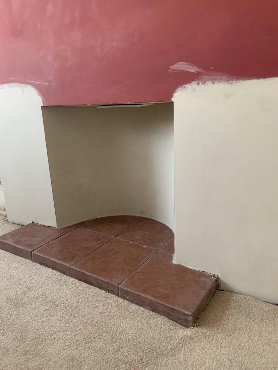 The same chimney breast after treatment, replastered around the fireplace opening and left to dry before decorating